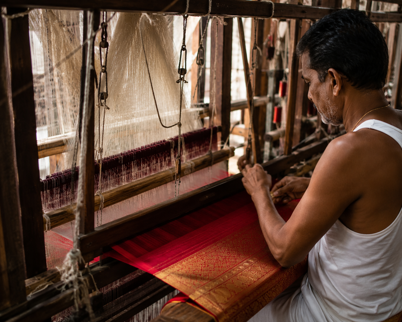 Artisan weaving silk on a handloom